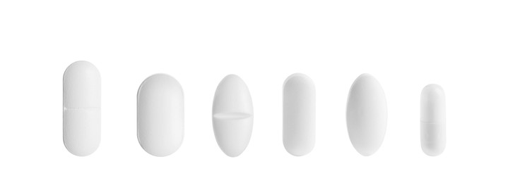 Set of different pills in row isolated on white