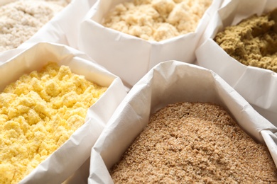 Different types of flour in paper bags