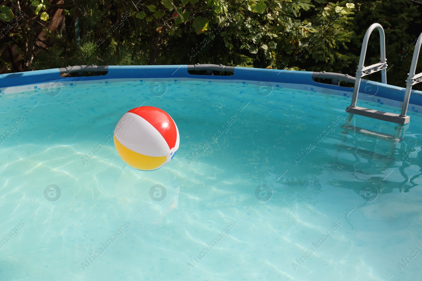 Photo of Inflatable ball on water in above ground swimming pool outdoors