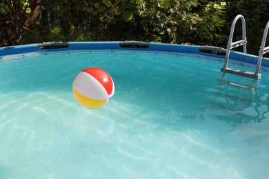 Photo of Inflatable ball on water in above ground swimming pool outdoors