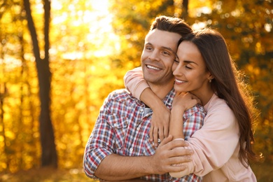 Photo of Happy couple in sunny park. Autumn walk