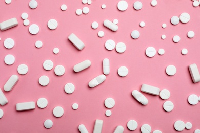 Photo of Different pills and capsules on color background, flat lay