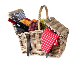 Photo of Wicker picnic basket with wine and different products on white background