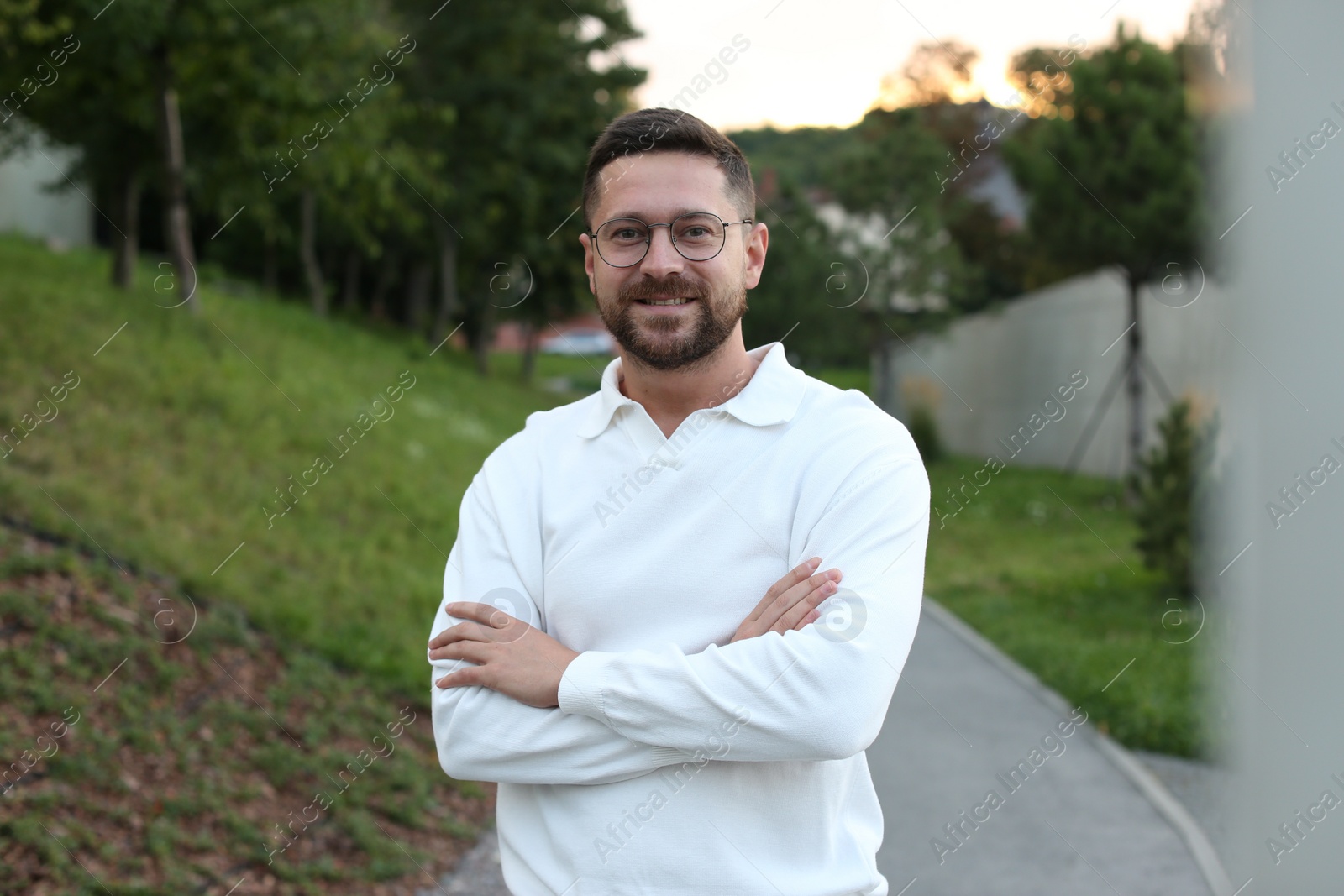 Photo of Portrait of handsome bearded man in glasses outdoors