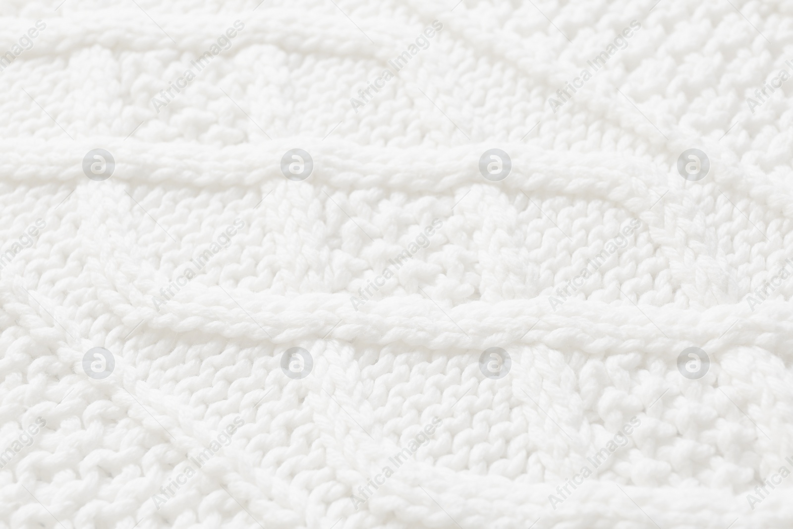 Image of White knitted fabric with beautiful pattern as background, closeup