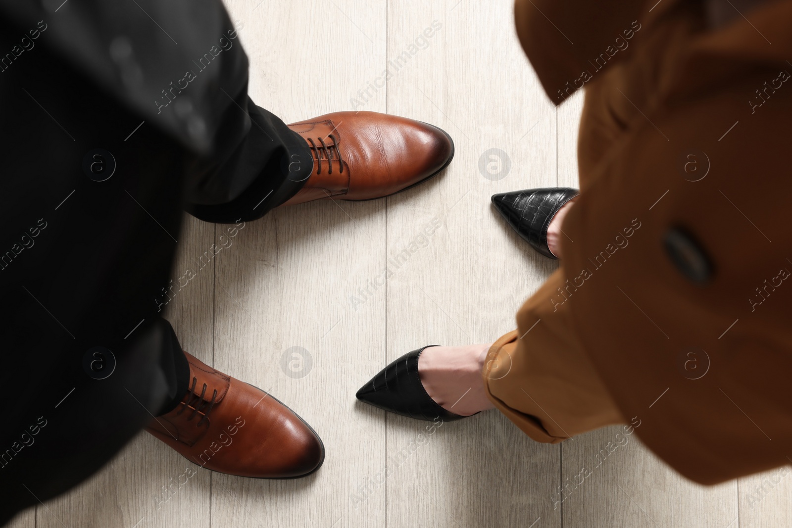 Photo of Businessman and businesswoman in elegant shoes on floor, above view