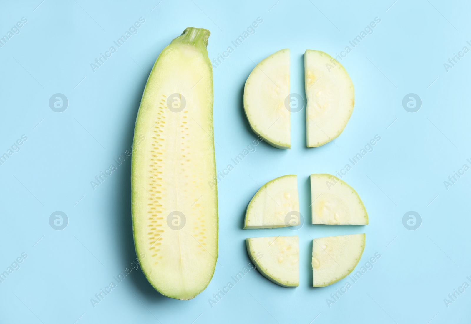 Photo of Fresh ripe green zucchini on light blue background, flat lay