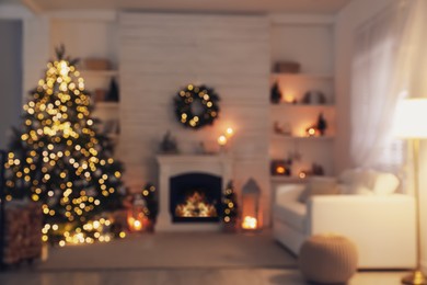 Photo of Blurred view of stylish living room interior with decorated Christmas tree and comfortable sofa