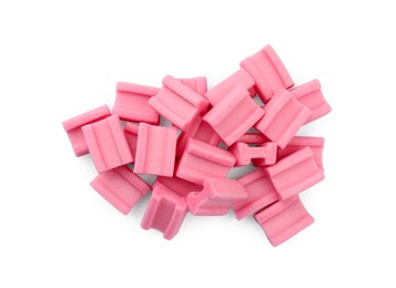 Photo of Pile of tasty pink chewing gums on white background, top view