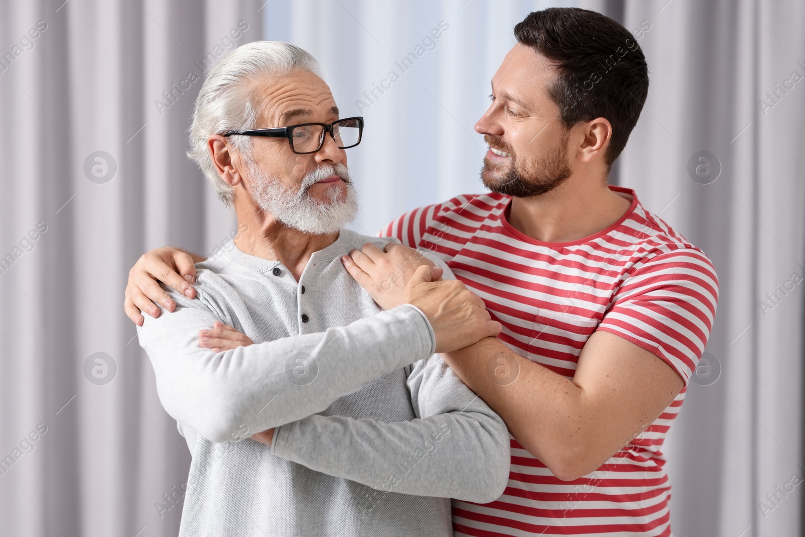 Photo of Happy son and his dad at home