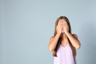 Photo of Young woman being blinded on grey background, space for text