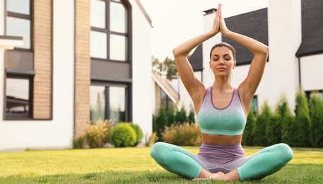 Woman practicing morning yoga at backyard. Healthy lifestyle