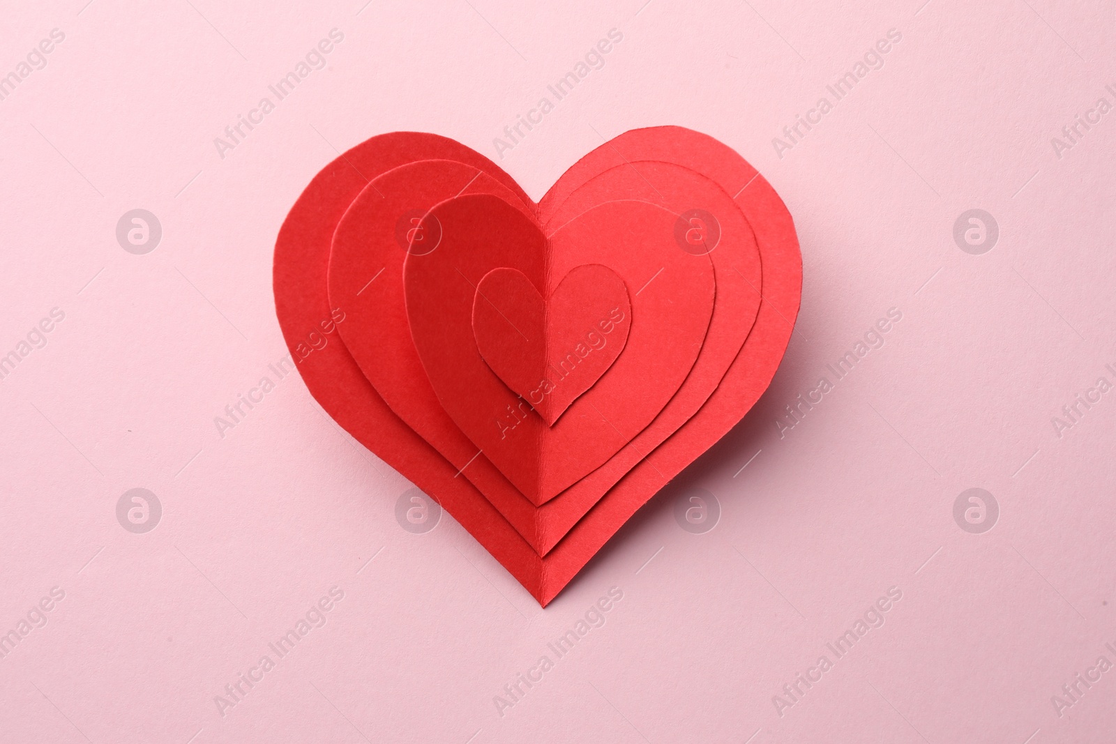 Photo of Paper hearts on pink background, top view