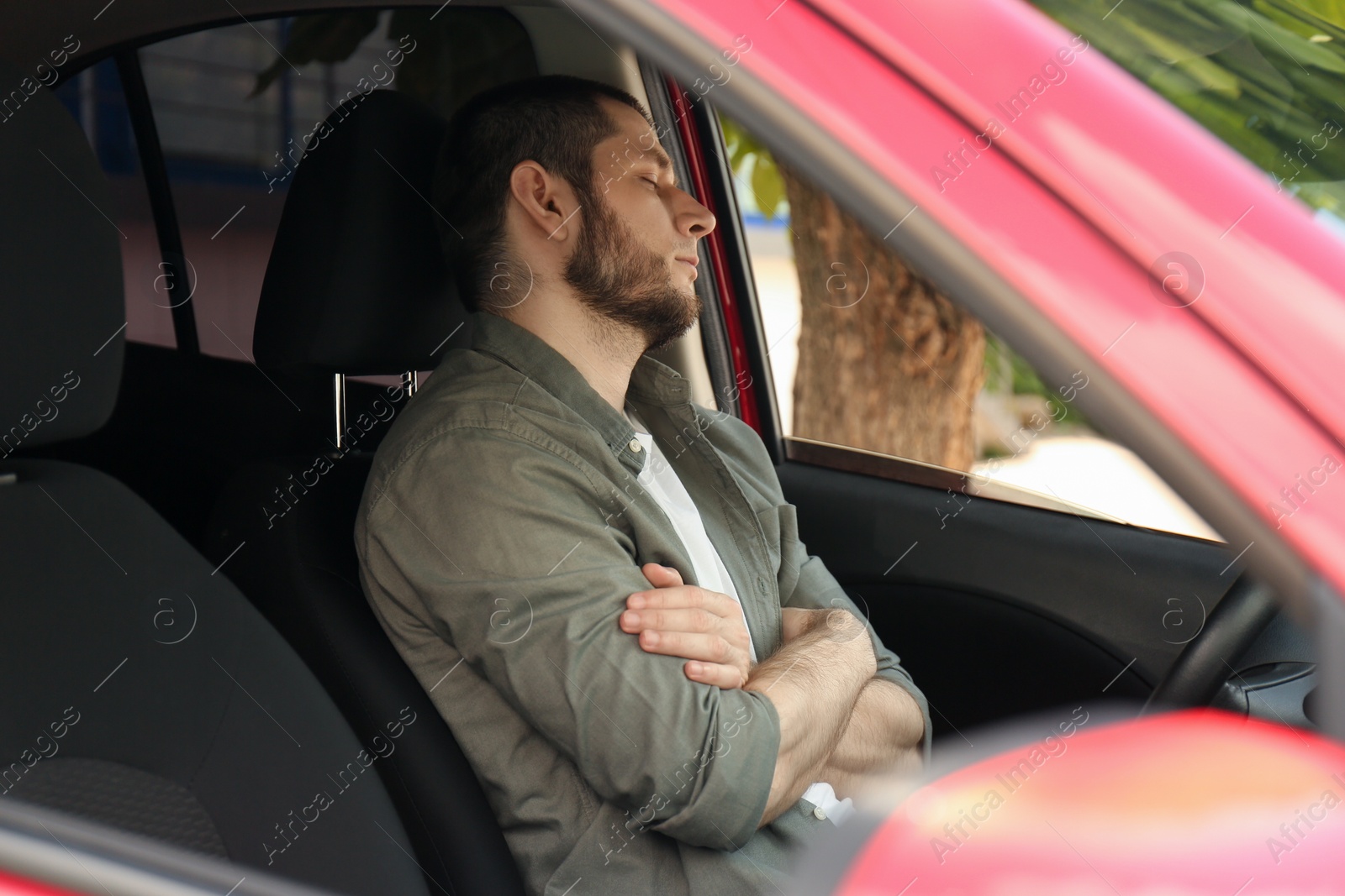 Photo of Tired man sleeping in his modern car