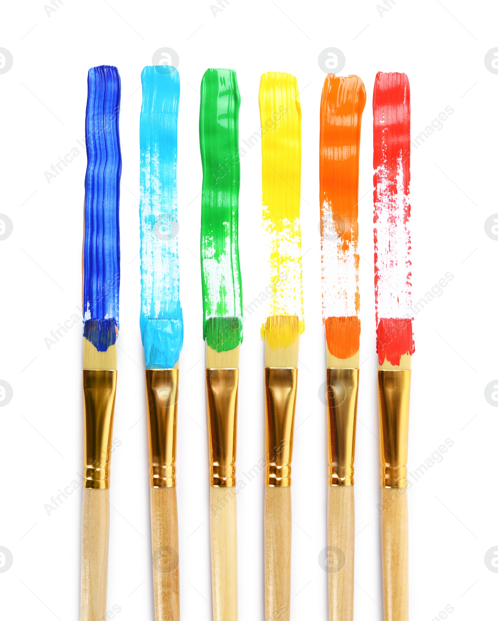 Photo of Brushes with colorful paints and strokes on white background, top view