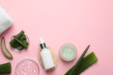 Photo of Flat lay composition with cosmetic products and cut aloe leaves on pink background. Space for text