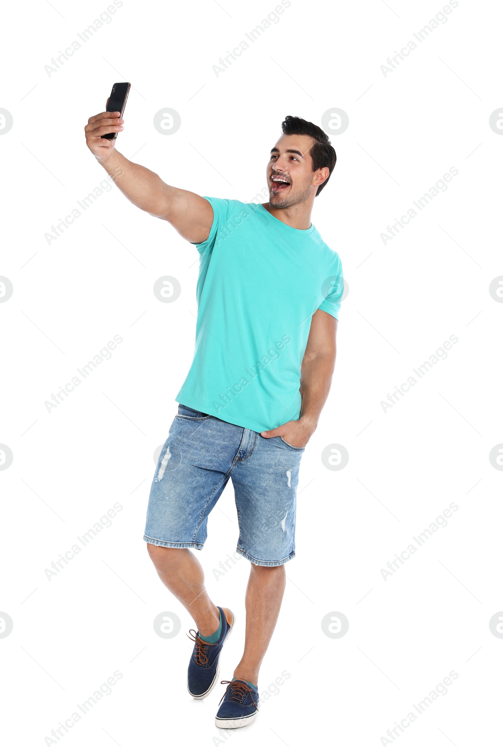 Photo of Happy young man taking selfie on white background