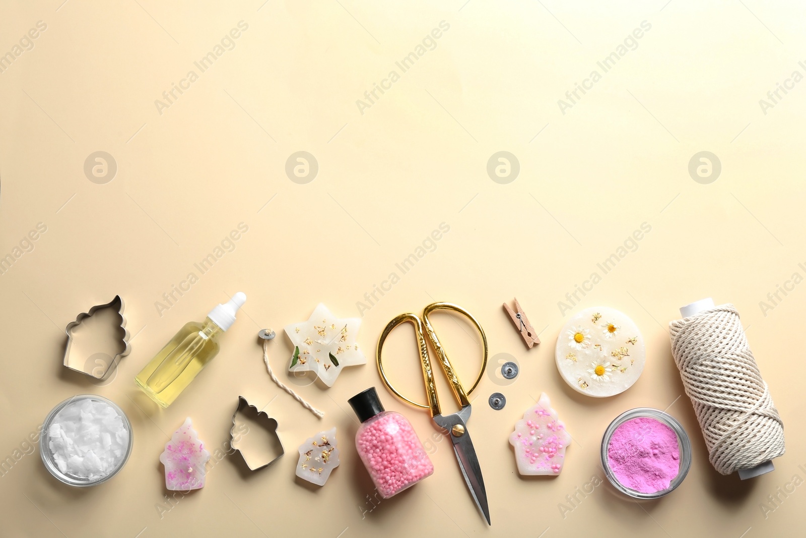 Photo of Flat lay composition with handmade candles and tools on color background. Space for text