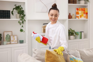 Photo of Spring cleaning. Young woman tidying up room at home