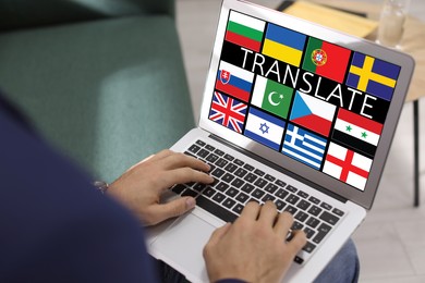 Image of Translator using modern laptop with images of different flags on screen in office, closeup