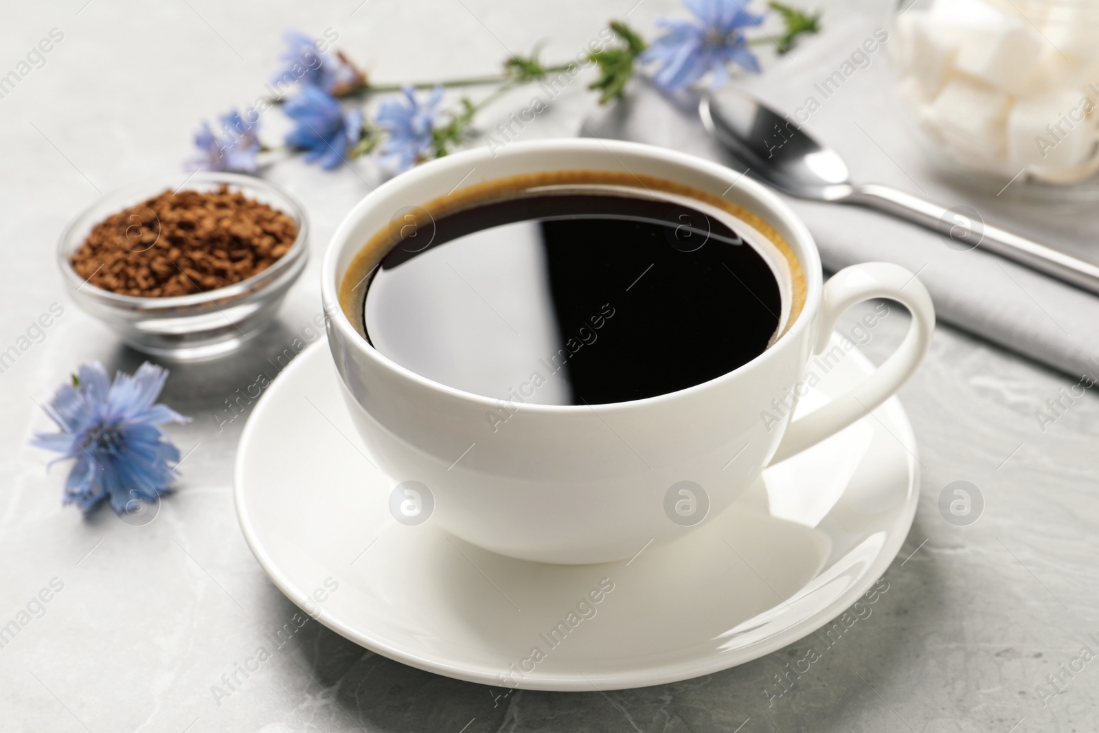 Photo of Cup of delicious chicory drink on light grey marble table, closeup