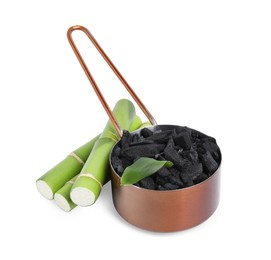 Photo of Fresh bamboo and charcoal on white background