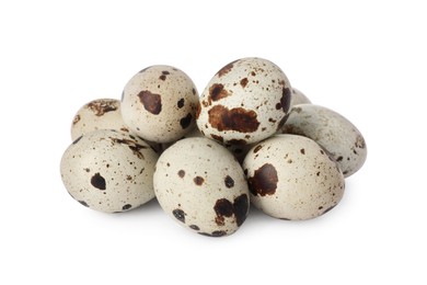 Many speckled quail eggs on white background