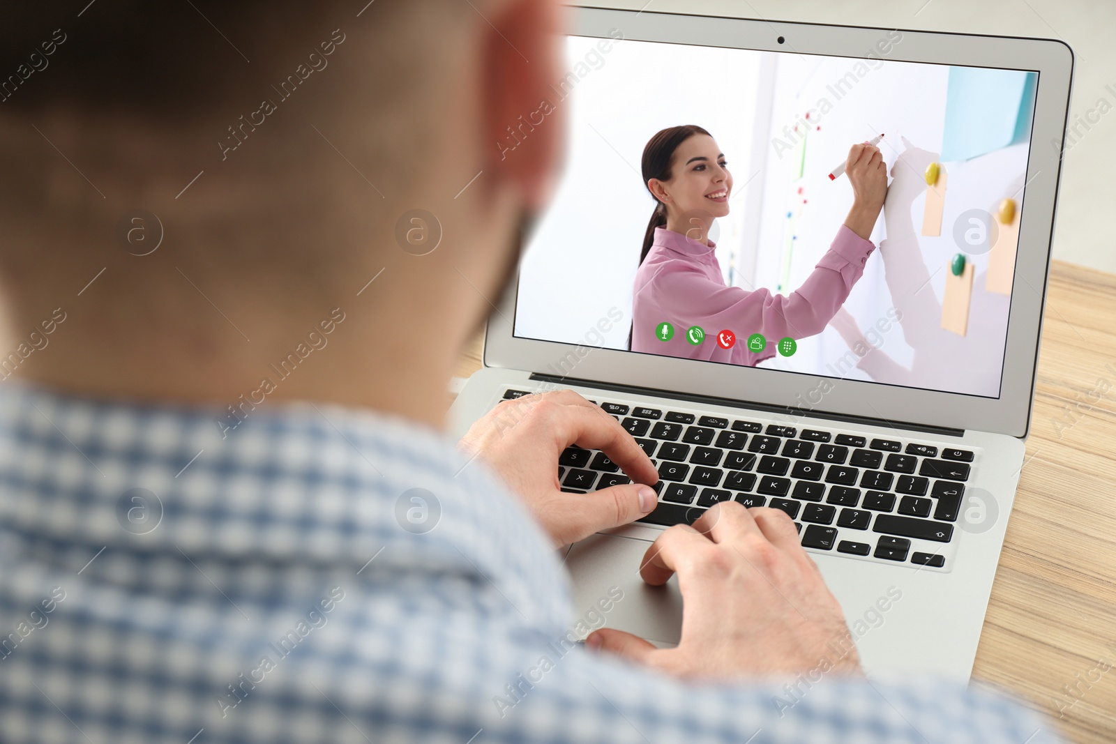 Image of Young man watching video at desk, closeup. Online learning
