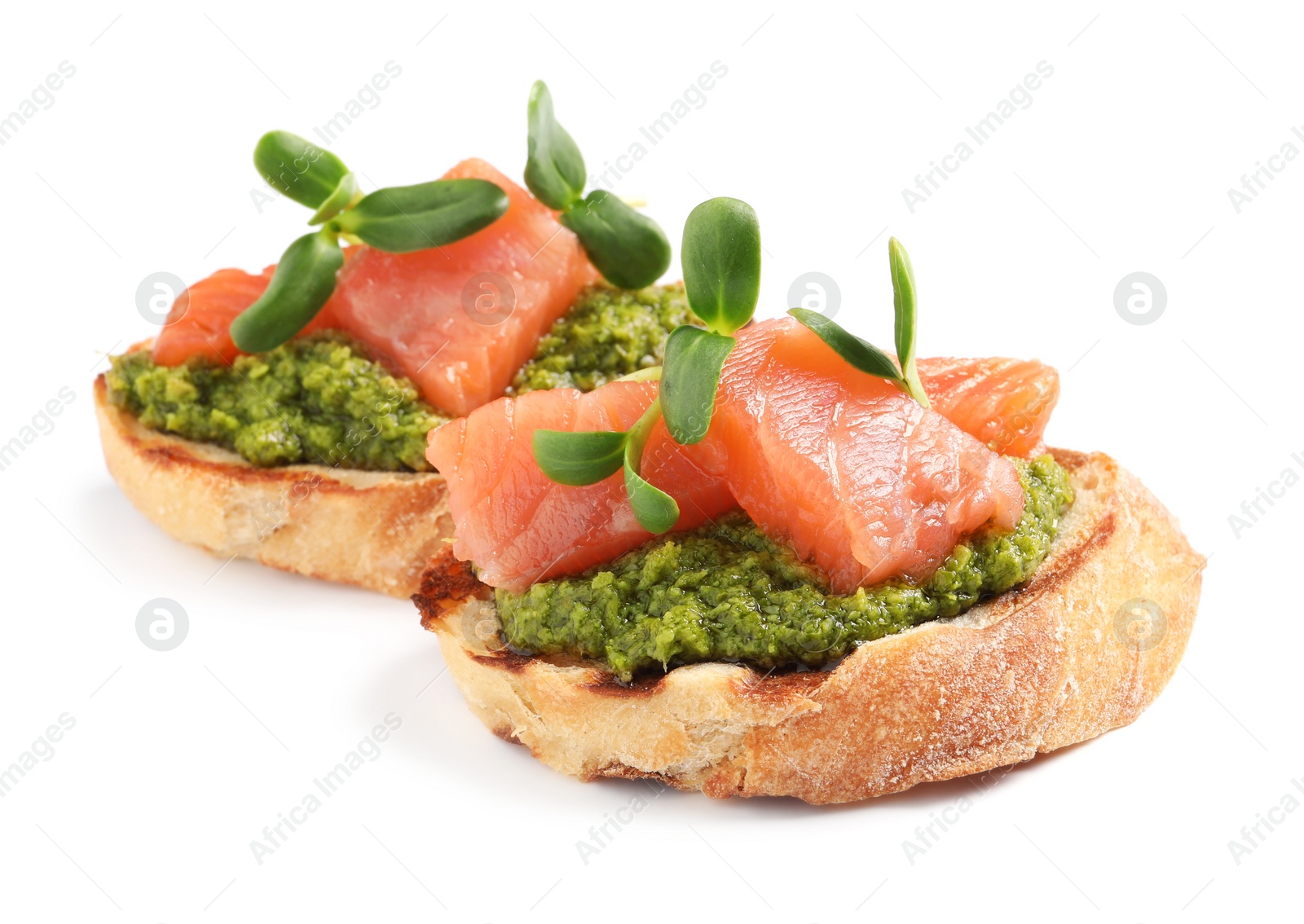 Photo of Delicious bruschettas with salmon, pesto sauce and microgreens on white background