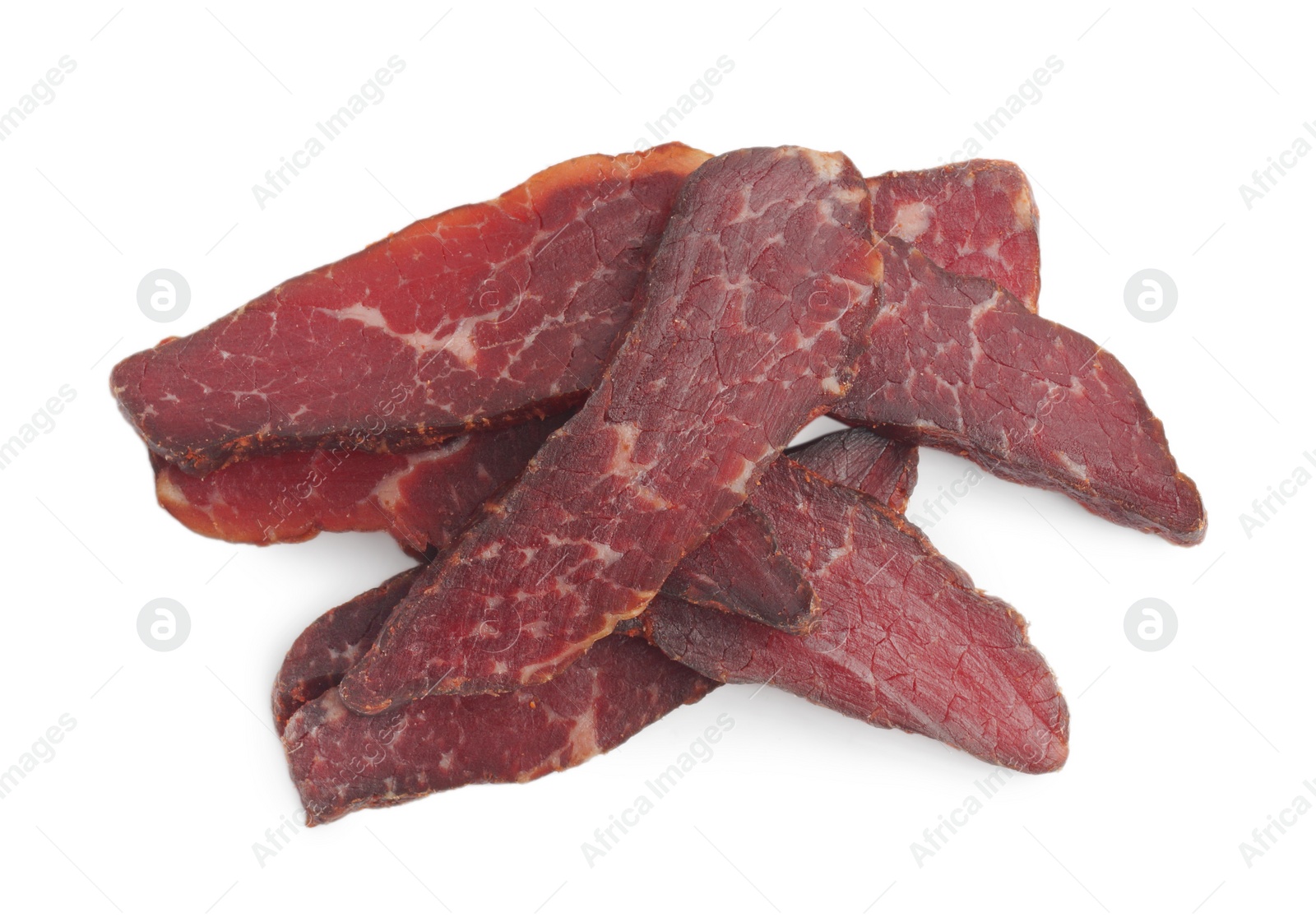 Photo of Pieces of delicious beef jerky on white background, above view