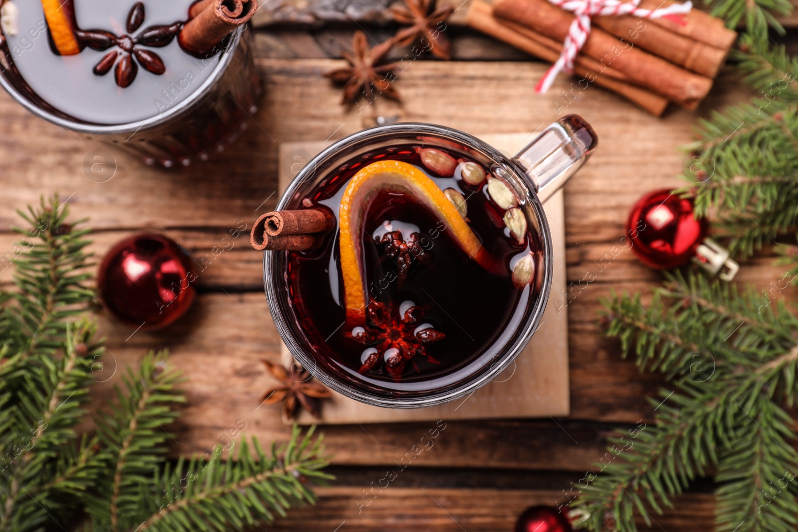 Photo of Flat lay composition with aromatic mulled wine on wooden table