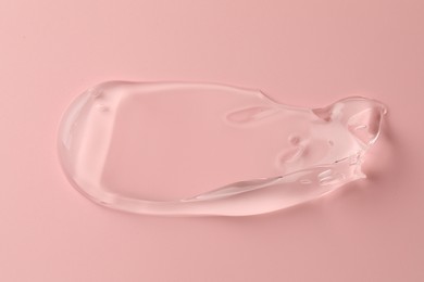 Photo of Sample of clear cosmetic gel on pink background, top view