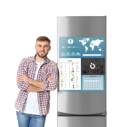 Image of Young man  near smart refrigerator on white background