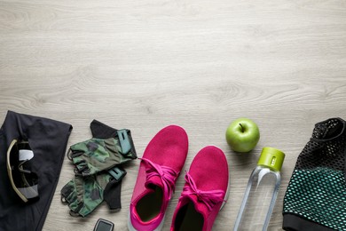 Photo of Flat lay composition with different cycling accessories on wooden background, space for text