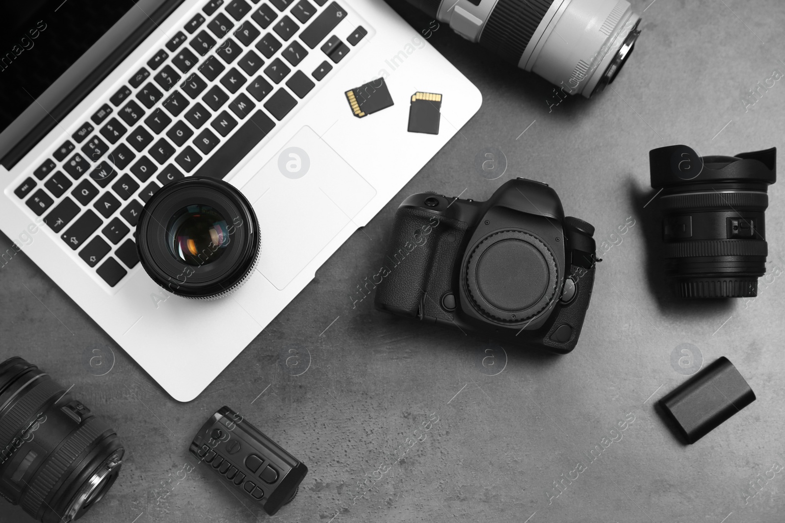 Photo of Professional photographer equipment and laptop on gray background, top view