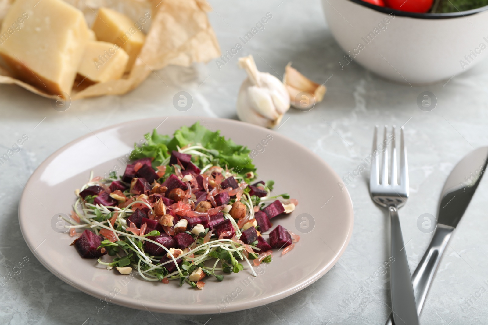 Photo of Delicious carrot salad served on grey table