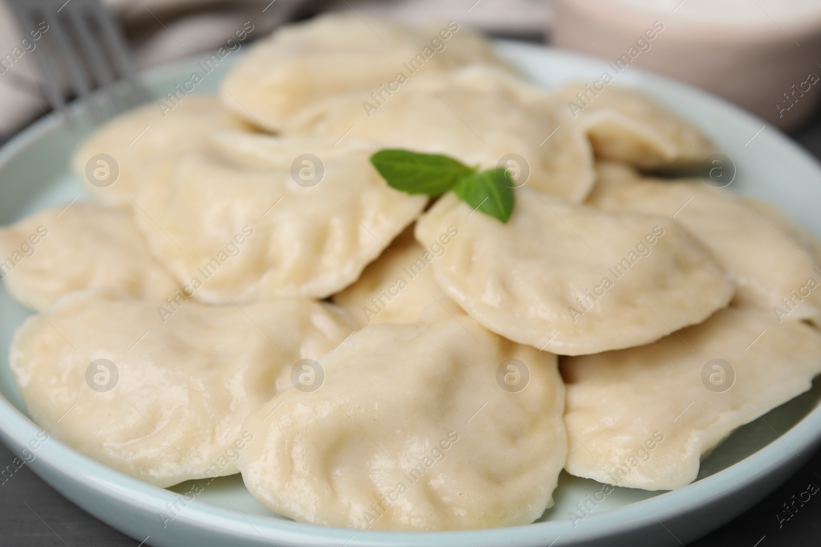 Photo of Plate of delicious dumplings (varenyky) on table, closeup