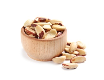 Wooden bowl with Brazil nuts on white background