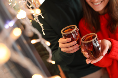 Photo of Lovely couple with tasty mulled wine outdoors, closeup
