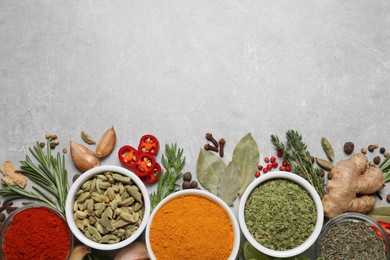 Photo of Flat lay composition with different natural spices and herbs on light grey table, space for text