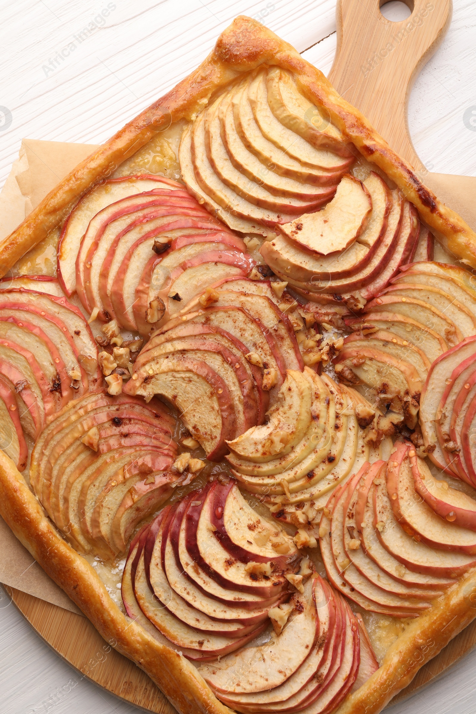 Photo of Tasty fresh apple galette on white wooden table, top view