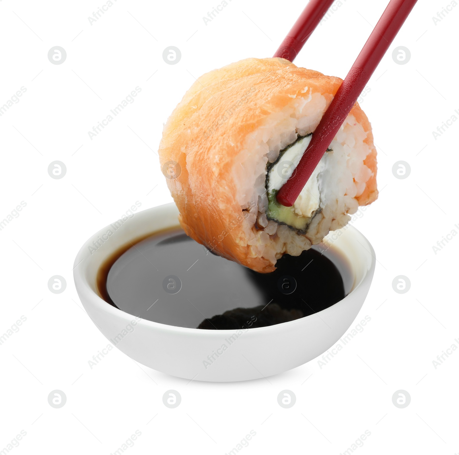 Photo of Dipping tasty sushi into soy sauce isolated on white