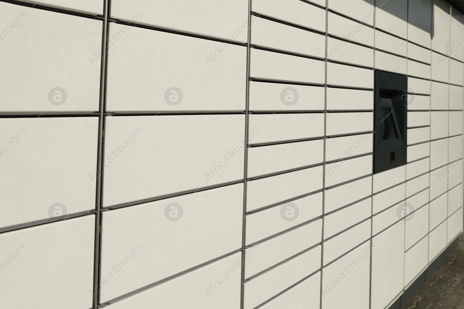 Photo of Modern parcel locker with many postal boxes outdoors