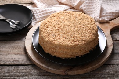 Photo of Delicious Napoleon cake served on wooden table