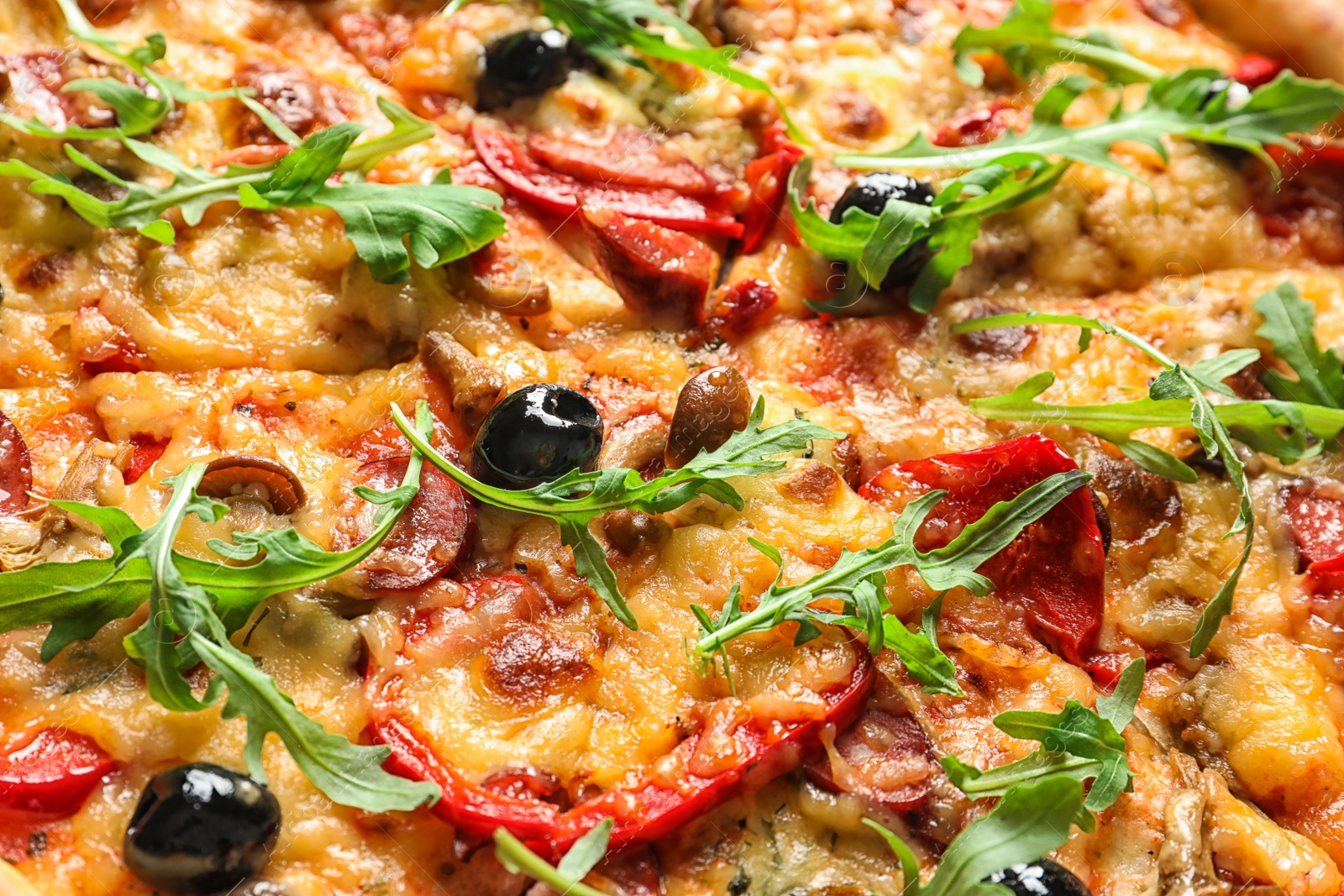 Photo of Delicious pizza with olives and sausages, closeup