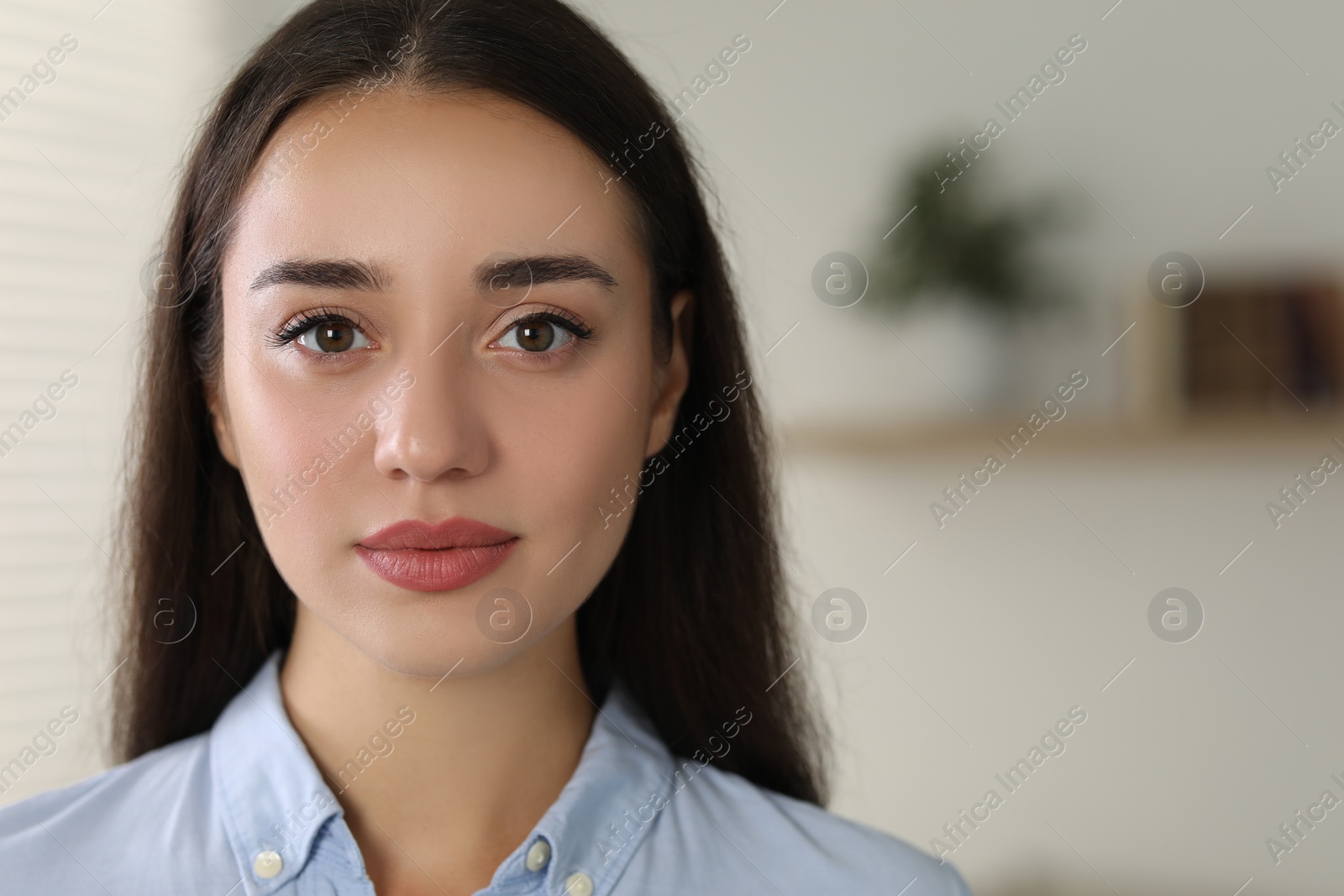 Photo of Portrait of beautiful young woman indoors. Space for text
