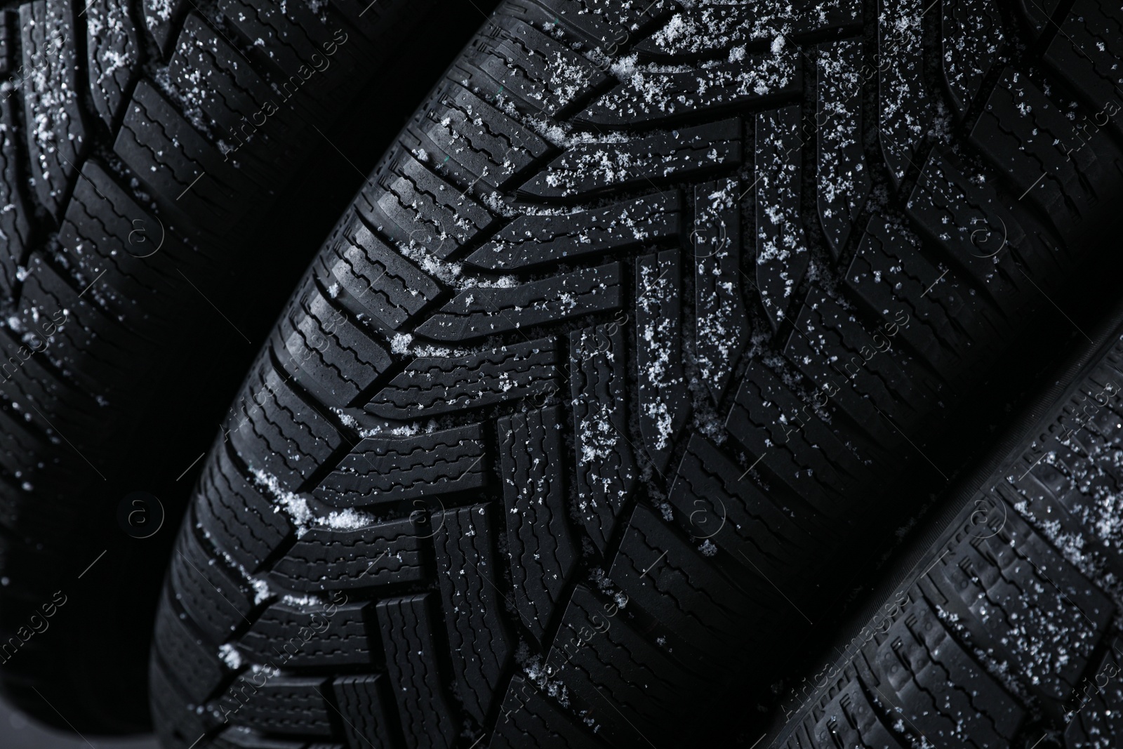 Photo of Snowy new winter tires as background, closeup