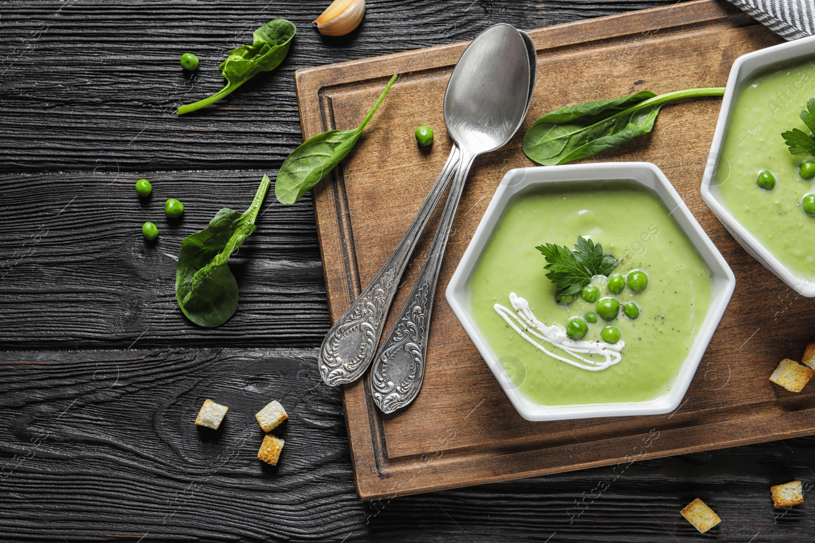 Photo of Fresh vegetable detox soup made of green peas served on table, top view. Space for text