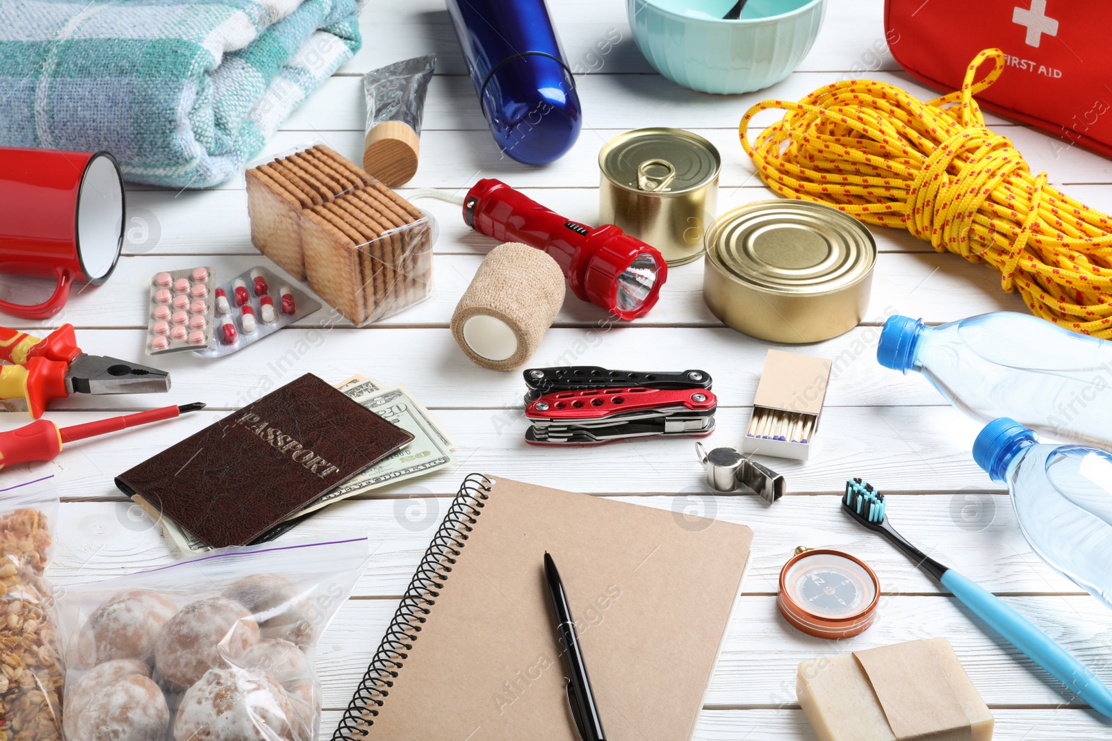 Photo of Disaster supply kit for earthquake on white wooden table