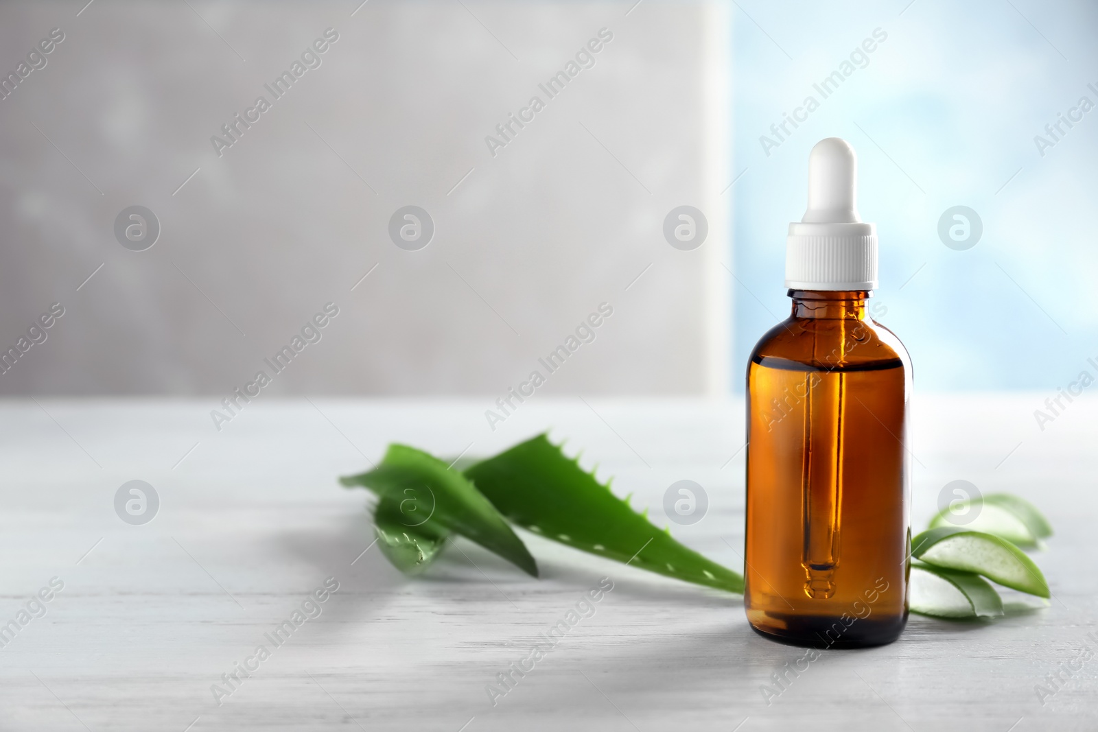 Photo of Bottle of aloe essential oil on table